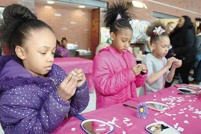 THINKING POSITIVES—These three young ladies are putting words on their mirrors so that every time they look into the mirror, a positive message is displayed.
