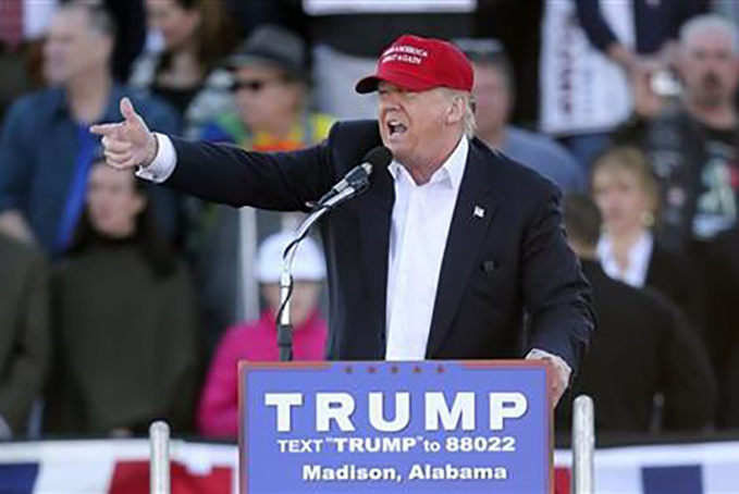 Republican presidential candidate Donald Trump points as he speaks during a rally Sunday, Feb. 28, 2016, in Madison, Ala. (AP Photo/John Bazemore)