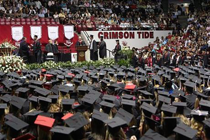 FILE - In this Aug. 6, 2011, file photo, University of Alabama students receive their diplomas during the morning commencement ceremony for spring and summer graduates at Coleman Coliseum in Tuscaloosa, Ala. While 58 percent of black male undergraduates at the 65 schools in the Power 5 conferences got degrees within six years, 54 percent of black male student-athletes at the same schools graduated, according to an analysis of the 2014-2015 academic year by University of Pennsylvania researcher Shaun Harper. (Michelle Lepianka Carter/The Tuscaloosa News via AP, File) NO SALES; MANDATORY CREDIT