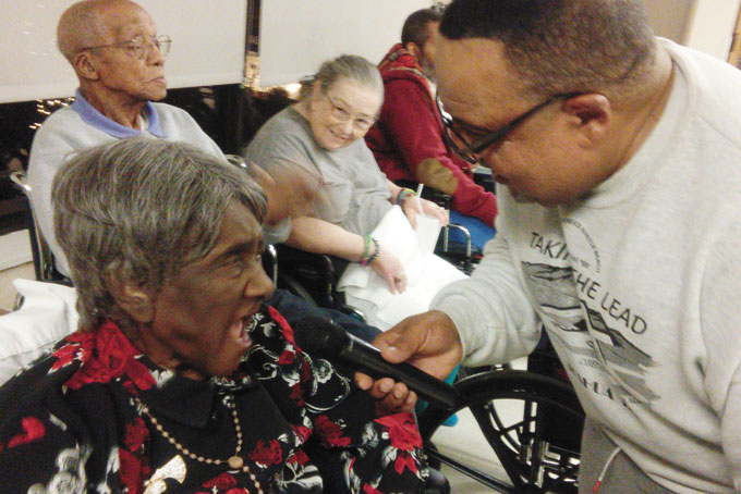 BESSIE HILL, a resident, leading the choir.