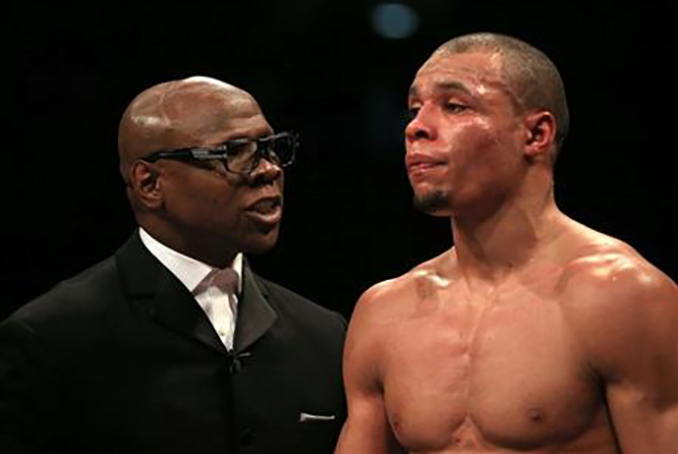  hisis a Feb. 28, 2015 file photo of Chris Eubank Sr, left, speaks to his son Chris Eubank Jr at the O2 Arena, London. British boxer Nick Blackwell lies in an induced coma in a hospital in London Monday March 28, 2016 following a brutal middleweight title fight against Chris Eubank Jr. (Nick Potts/PA via AP) 