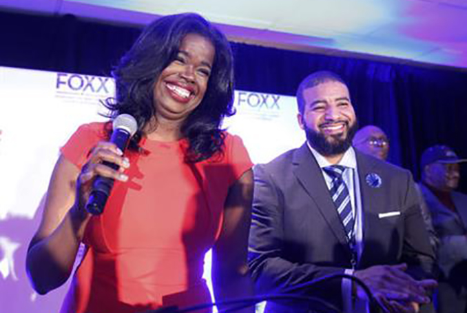 Challenger Kim Foxx smiles at the crowd with her husband Kelley, as they celebrate her primary win over incumbent Democratic Cook County State's Attorney Anita Alvarez Tuesday, March 15, 2016, in Chicago. (AP Photo/Charles Rex Arbogast)