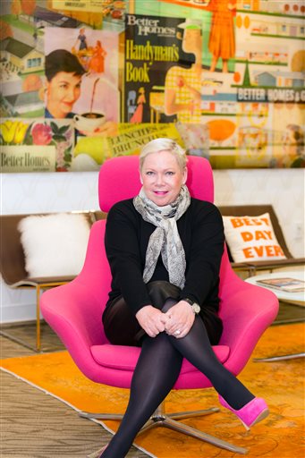 This image released by Better Homes and Gardens Real Estate shows Sherry Chris, president and chief executive of Better Homes and Gardens Real Estate sits in an office chair made in her signature pink in Madison, N.J. Chris is one of only two individuals who have requested custom colors from the Pantone Color Institute. The other person is Jay Z. (Better Homes and Gardens Real Estate via AP)