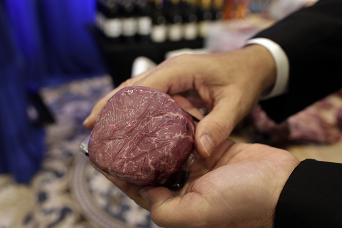 A Donald Trump branded steak is shown prior to a news conference by Republican presidential candidate Donald Trump, Tuesday, March 8, 2016, in Jupiter, Fla. Trump branded steaks, wine, and water were on display next to the stage at the Trump National Golf Club. (Lynne Sladky/Associated Press)