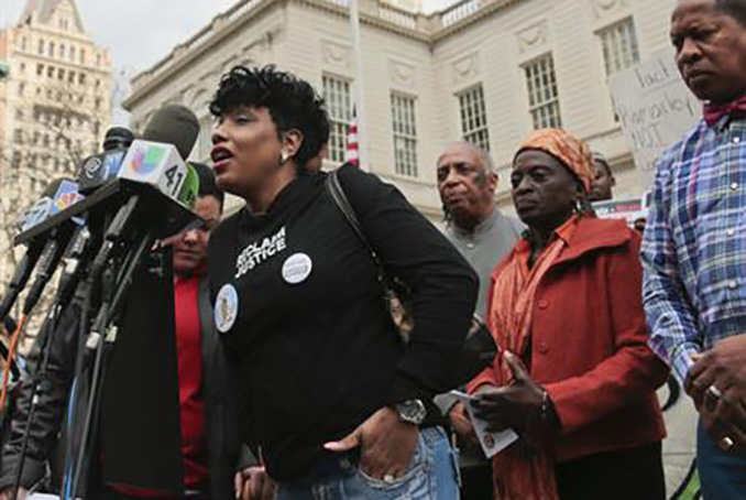  Wearing a memorial photo button of her son Ramarley Graham, Constance Malcolm, center, is surrounded by city council members and a coalition of civil rights activists as she speaks during a rally on the steps of City Hall, calling for justice in the police killing of Graham, Thursday, March 10, 2016, in New York. (AP Photo/Bebeto Matthews)