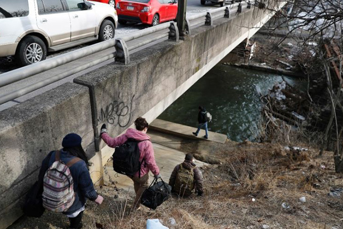  In this Feb. 19, 2016, photo, medical assistant Lina Marin, from left, registered nurse Laura Lacroix, physician assistant Brett Feldman and community outreach specialist Bob Rapp visit a homeless camp under a bridge in Allentown, Pa. (AP Photo/Matt Slocum) 