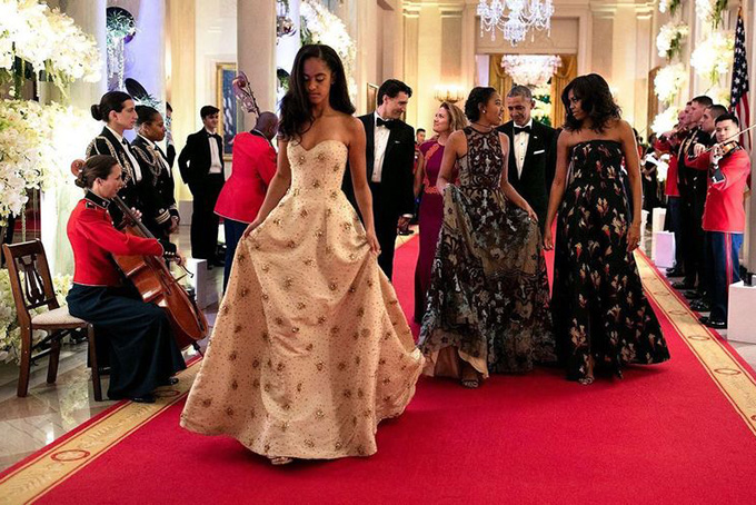 Malia Obama, left, and her sister Sasha walk out of their first State Dinner with their parents. — Image Source: Official White House Photo by Sete Souza