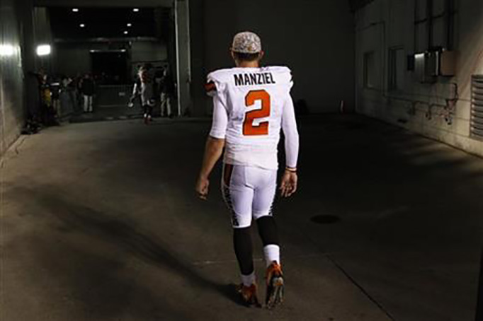 FILE - In this Nov. 5, 2015, file photo, Cleveland Browns quarterback Johnny Manziel walks off the field after an 31-10 loss to the Cincinnati Bengals, in Cincinnati. The Browns have released troublesome quarterback Johnny Manziel. The team cut ties on Friday, March 11, 2016, with the 2012 Heisman Trophy winner after two disappointing, drama-filled seasons. (AP Photo/Frank Victores, File)