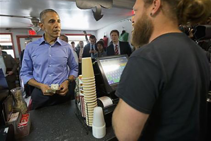 President Barack Obama places his taco order with Torchy’s Tacos owner Aaron Sego, right, during an unannounced stop at Torchy’s Tacos, Friday, March 11, 2016, in Austin, Texas. Obama traveled to Austin, to speak at South by Southwest Festival (SXSW) and attend two Democratic National Committee fundraisers. (AP Photo/Pablo Martinez Monsivais)