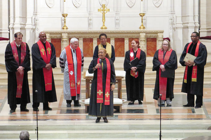 PROUD NEW MINISTER—Rev. Patrice Fowler-Searcy, center, speaks as other ministers look on.