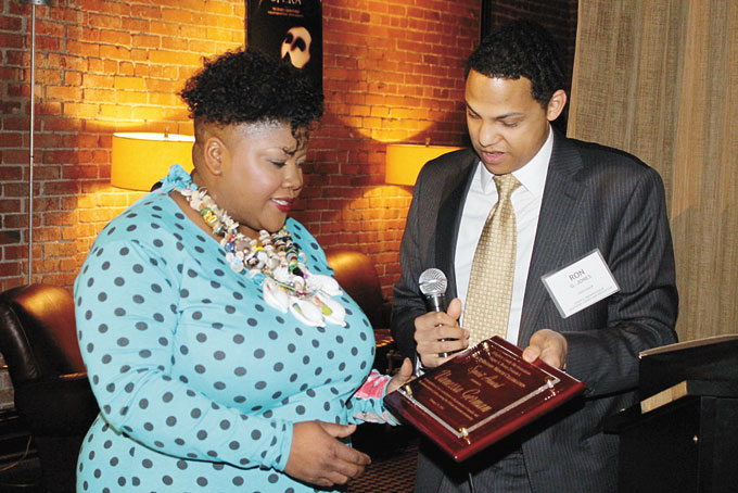 RECEIVING HER AWARD—Vanessa German gets her award from Ron G. Jones. 