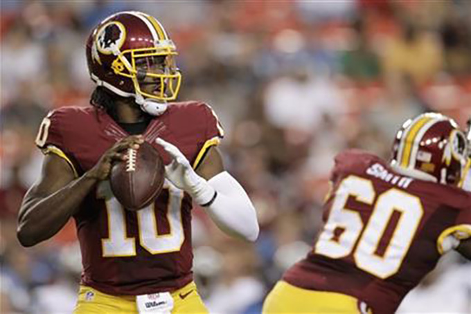 In this photo taken Aug. 20, 2015, Washington Redskins quarterback Robert Griffin III (10) passes the ball during the first half of an NFL preseason football game against the Detroit Lions in Landover, Md. (AP Photo/Mark Tenally)