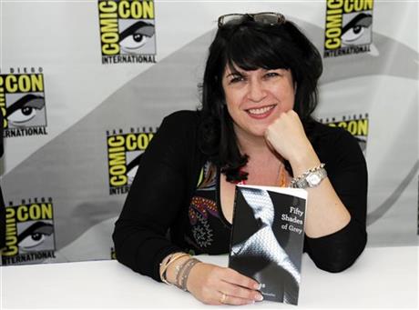 In this July 12, 2012, file photo, author E.L. James poses with her book "Fifty Shades of Grey" at a book signing at Comic-Con in San Diego. (Photo by Denis Poroy/Invision/AP, File)