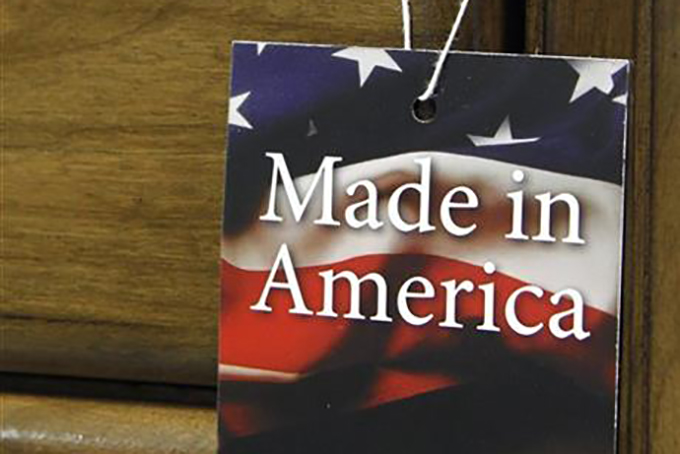 In this March 16, 2012 file photo, a "Made in America" tag hangs on a chest of drawers at a furniture factory in Lincolnton, N.C. The vast majority of Americans say they prefer lower prices instead of paying a premium for items labeled “Made in the U.S.A.,” even if it means those cheaper items are made abroad, according to an Associated Press-GfK poll. (AP Photo/Bob Leverone, File)