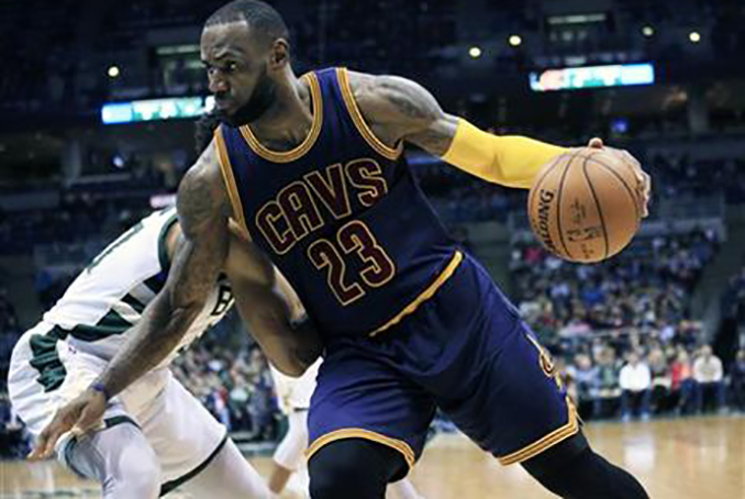 Cleveland Cavaliers forward LeBron James drives to the basket against the Milwaukee Bucks during the first half of an NBA basketball game Tuesday, April 5, 2016, in Milwaukee. (AP Photo/Darren Hauck)