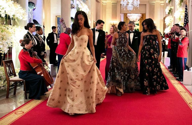 Malia Obama, left, and her sister Sasha walk out of their first State Dinner with their parents. — Image Source: Official White House Photo by Sete Souza