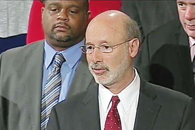 NEW LAW—As state Rep. Ed Gainey looks on, Gov. Tom Wolf fields questions after signing legislation legalizing medical marijuana in Pennsylvania, April 17. 