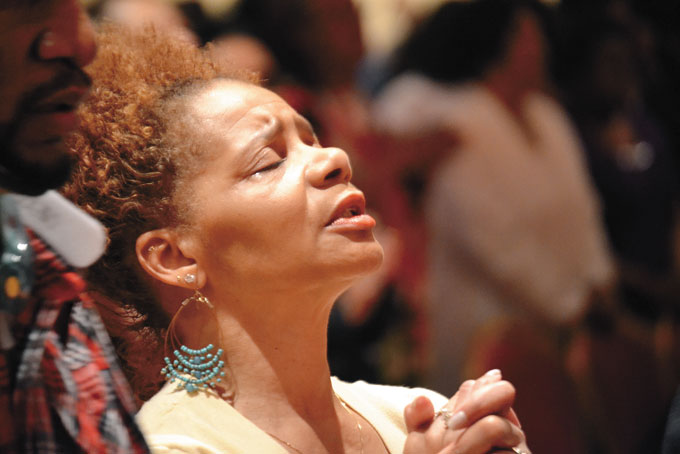 RECEIVING THE WORD—A member in prayer.