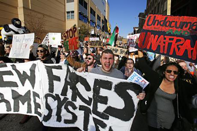 A group of protesters march through downtown Pittsburgh to the David Lawrence Convention Center to protest a visit by Republican presidential candidate Donald Trump in Pittsburgh, Wednesday, April 13, 2016. (AP Photo/Gene J. Puskar)