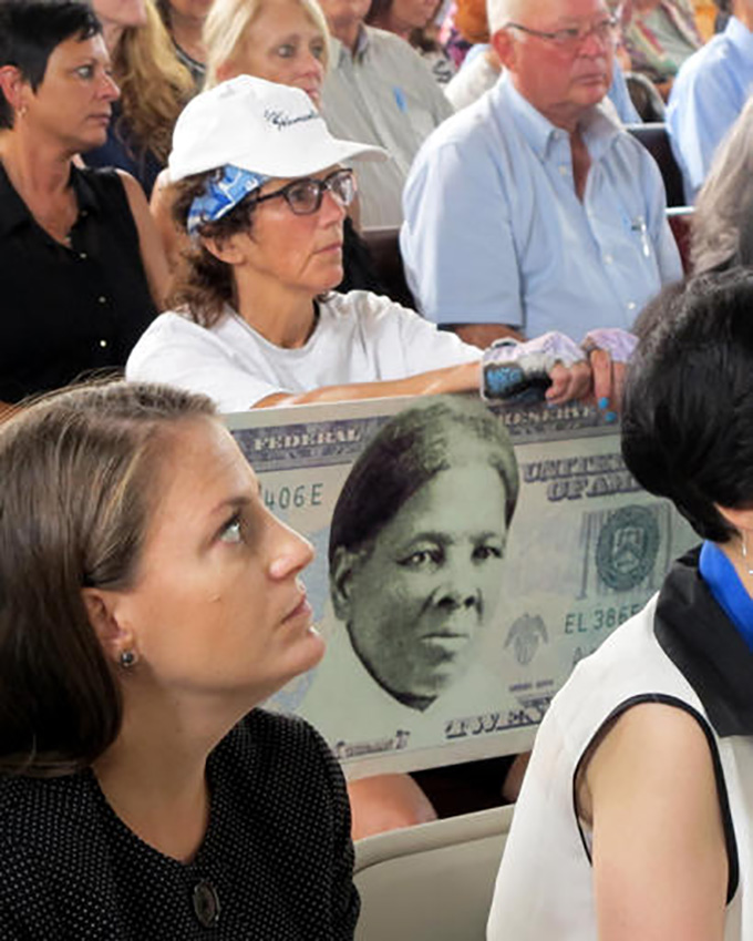 In this Monday, Aug. 31, 2015, file photo, a woman holds a sign supporting Harriet Tubman for the $20 bill during a town hall meeting at the Women's Rights National Historical Park in Seneca Falls, N.Y. (AP Photo/Carolyn Thompson, File)