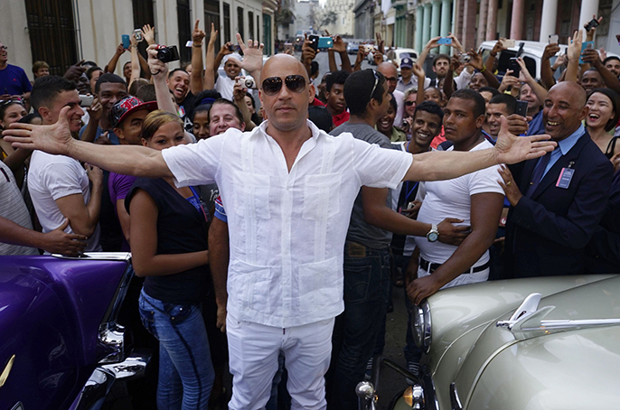 U.S. Actor Vin Diesel gestures during the presentation of fashion designer Karl Lagerfeld's "cruise" line for fashion house Chanel, at the Paseo del Prado street in Havana, Cuba, Tuesday, May 3, 2016. With the heart of the Cuban capital effectively privatized by an international corporation under the watchful eye of the Cuban state, the premiere of Chanel 2016/2017 "cruise" line offered a startling sight in a country officially dedicated to social equality and the rejection of material wealth. (AP Photo/Ramon Espinosa)