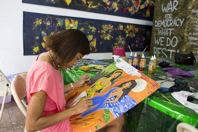 In this May 28, 2016 photo, Stephanie Thomas paints during an acrylics painting class with Haitian artist Frantz Zephirin, that she attends every weekend, at the resurrected Centre d’Art or Art Center in Port-au-Prince, Haiti. Encouraging serious Haitian artists has been the core part of the center’s mission since its founding in 1944 by Dewitt Peters, a U.S. watercolorist who came to Haiti to teach English. (AP Photo/Dieu Nalio 