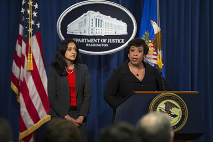 Vanita Gupta, head of the Justice Department's civil rights division listens at left as Attorney General Loretta Lynch speaks during a news conference at the Justice Department of Justice in Washington, Monday, May 9, 2016. North Carolina Gov. Pat McCrory's administration sued the federal government Monday in a fight for a state law that limits protections for lesbian, gay, bisexual and transgender people. (AP Photo/Evan Vucci)