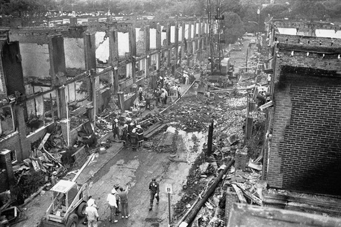 Police, firemen and workers search through the rubble on Osage Avenue in West Philadelphia, May 15, 1985 in the aftermath of the blaze, which destroyed 61 homes in the neighborhood. Eleven bodies were found in the rubble of the house that was occupied by members of the radical group MOVE. — AP Photo/George Widman