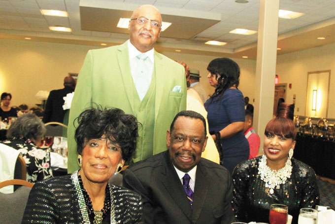 CELEBRATION—From left: Pastor Lorraine Williams with Bishop Loran and First Lady Barbara Mann. Standing is Pastor Gregory Perkins.
