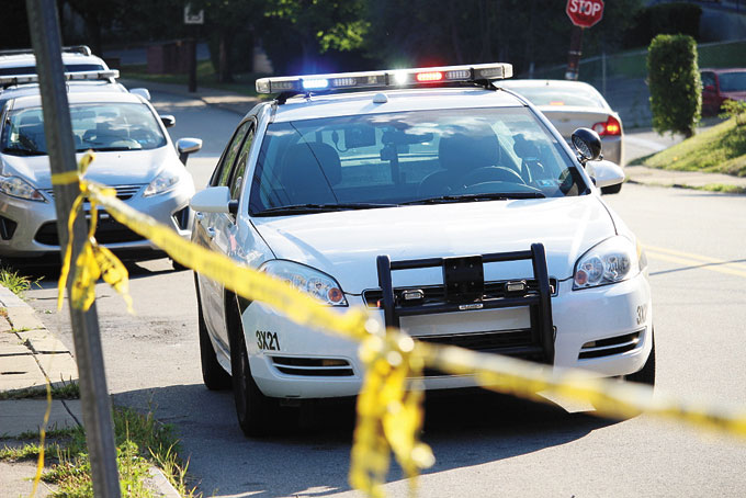 CRIME SCENE—Caution tape and flashing police lights mark the sight of another city homicide. (Photo by J.L. Martello)
