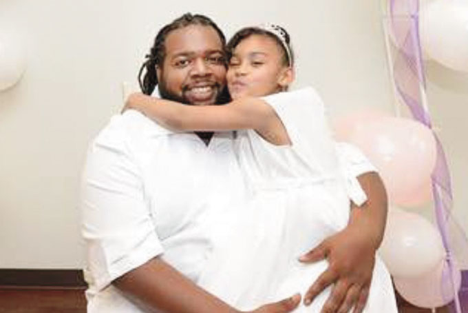 FATHER HOLDS DAUGHTER