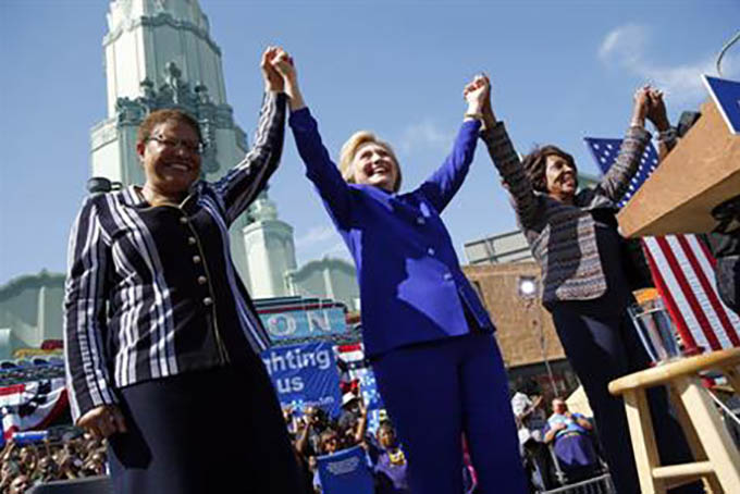 Democratic presidential candidate Hillary Clinton, center, celebrates at a rally with Rep. Karen Bass, D-Calif., left, and Rep. Maxine Waters, D-Calif., Monday, June 6, 2016, in Los Angeles. (AP Photo/John Locher)