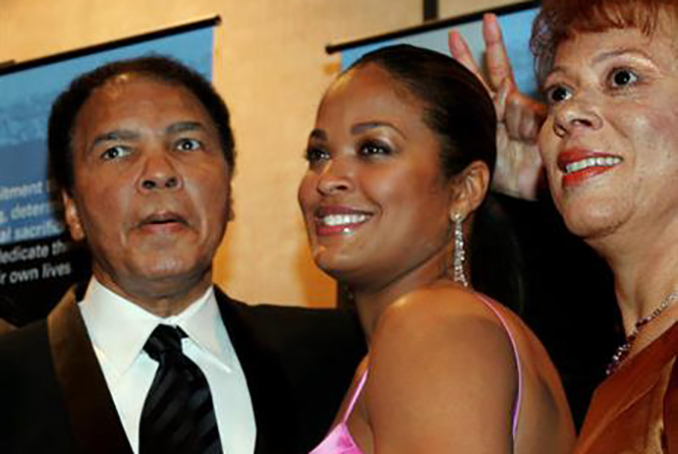 FILE - In this Feb. 26, 2005, file photo, former heavyweight boxing champion Muhammad Ali, left, jokingly holds up two fingers behind the head of his daughter, Laila Ali, as they and his wife, Lonnie Ali, pose for cameras during a news conference before a tribute to him coinciding with Black History Month in Atlanta. Laila Ali told NBC's "Today" show on Monday, June 6, 2016 that her father is not suffering anymore. Muhammad Ali died Friday at 74 following a long battle with Parkinson's disease. (AP Photo/John Amis, File)