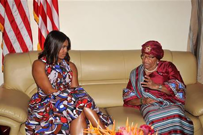 U.S. First lady Michelle Obama, left, listens to Liberian President Ellen Johnson Sirleaf, right, after she arrived at the airport in Monrovia, Liberia, Monday, June. 27, 2016. Obama is visiting a leadership camp for girls in Liberia to launch her latest Africa visit on Monday in a country still recovering from the recent Ebola epidemic that left thousands dead. (AP Photo/Abbas Dulleh)