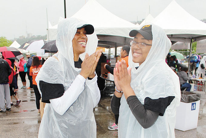 MOTIVATORS—Keeping everyone in a good mood and motivating walkers are Monique McCoy and Sapphire Mason clapping and dancing to the music. 