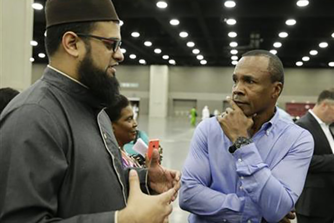 Safih Amed, left speaks with former boxing champion Sugar Ray Leonard before Muhammad Ali's Jenazah, a traditional Islamic Muslim service, in Freedom Hall, Thursday, June 9, 2016, in Louisville, Ky. (AP Photo/Darron Cummings)