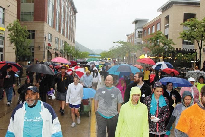 THERE’S NO STOPPING THEM—Thousands of people fight the rain to walk in the Highmark Health Walk.