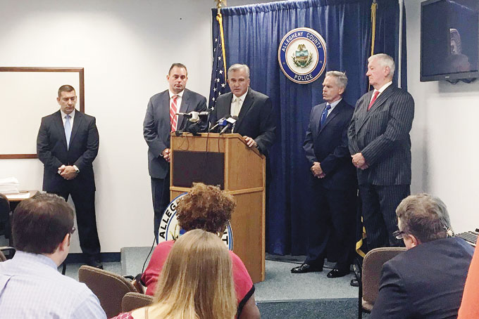 MAKING THE CASE—Joined by county police, District Attorney Stephen Zappala announces homicide charges against Robert Thomas and Cheron Shelton for the March 9 Wilkinsburg ambush.