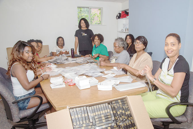 VOLUNTEERS—Nikkie Narvaez Manns, standing, with some of her volunteers who were packing 22,000 plus of her Magic Wands at the Hill CDC for shipment to QVC. (Photos by Gail Manker)