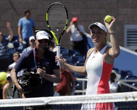 Caroline Wozniacki, of Denmark, prepares to hit balls to fans after defeating Taylor Townsend, of the United States, during the first round of the U.S. Open tennis tournament, Monday, Aug. 29, 2016, in New York. (AP Photo/Frank Franklin II) 