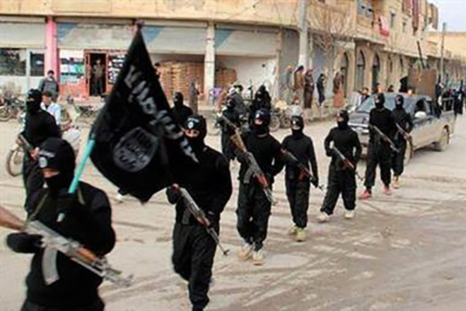 This undated file image posted on an extremist website on Jan. 14, 2014, shows fighters from the Islamic State group marching in Raqqa, Syria. (Militant photo via AP, File)
