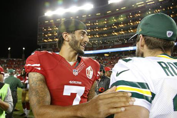 San Francisco 49ers quarterback Colin Kaepernick, left, greets Green Bay Packers quarterback Aaron Rodgers at the end of an NFL preseason football game Friday, Aug. 26, 2016, in Santa Clara, Calif. Green Bay won 21-10. (AP Photo/Tony Avelar)