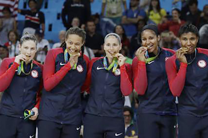 United States' Lindsay Whalen, from left, Seimone Augustus, Sue Bird, Maya Moore and Angel McCoughtry, pose with their gold medals after their win over Spain in a women's gold medal basketball game at the 2016 Summer Olympics in Rio de Janeiro, Brazil, Saturday, Aug. 20, 2016. (AP Photo/Eric Gay)