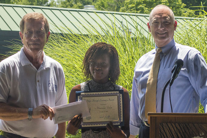 ONE OF FIVE—Mircalene Valcin, center, was one of five students to receive her award from HCEF Executive Director Bill Wolfe, left, and Chair of the HCEF Educational Resources and Programming Committee Jeff Martin. (Photo curtesy of HCEF) 
