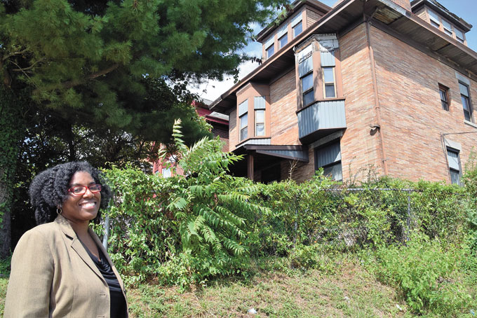 A BRIGHT FUTURE—Sonya Tilghman, executive director of the Hazelwood Initiative, stands at 5243 Gertrude Street, the future site of a homeownership incubator.(Photos by Diane I. Daniels) 