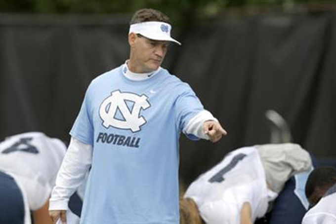 FILE - In this Aug. 10, 2015, file photo, North Carolina defensive coordinator Gene Chizik works with players during an NCAA college football practice in Chapel Hill, N.C. Chizik said the Tar Heels' defense played "soft" last week against James Madison and will have to play better against Pittsburgh "or this game could get ugly." (AP Photo/Gerry Broome, File)