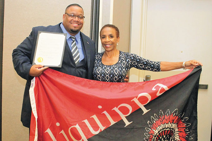 COMING BACK HOME—Aliquippa Mayor Dwan Walker presenting Aliquippa City Proclamation and flag to Karen Abercrombie. (Photos by Jackie McDonald) 