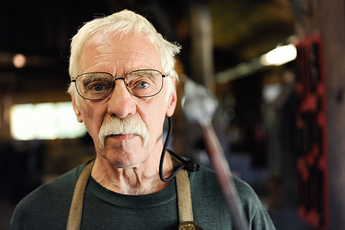 Blacksmith Dennis Gilkey performs his craft and works as facilities manager at the Touchstone Center for Crafts in the Laurel Highlands. (Photo by Sarah Collins/PublicSource)