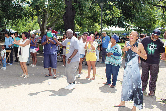 HAVING A GOOD TIME—Just a few of the groups of individuals who watched and enjoyed the Sankofa drummers and dancers.