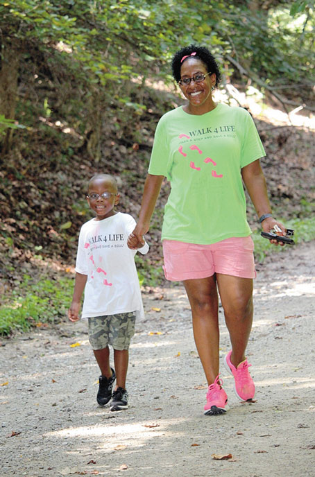 MOTHER AND SON—Danielle Brown and her son, Julain Brown, of Homestead, walking through the trails.